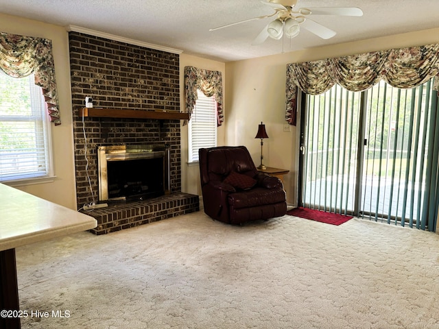carpeted living area featuring ceiling fan, a textured ceiling, and plenty of natural light