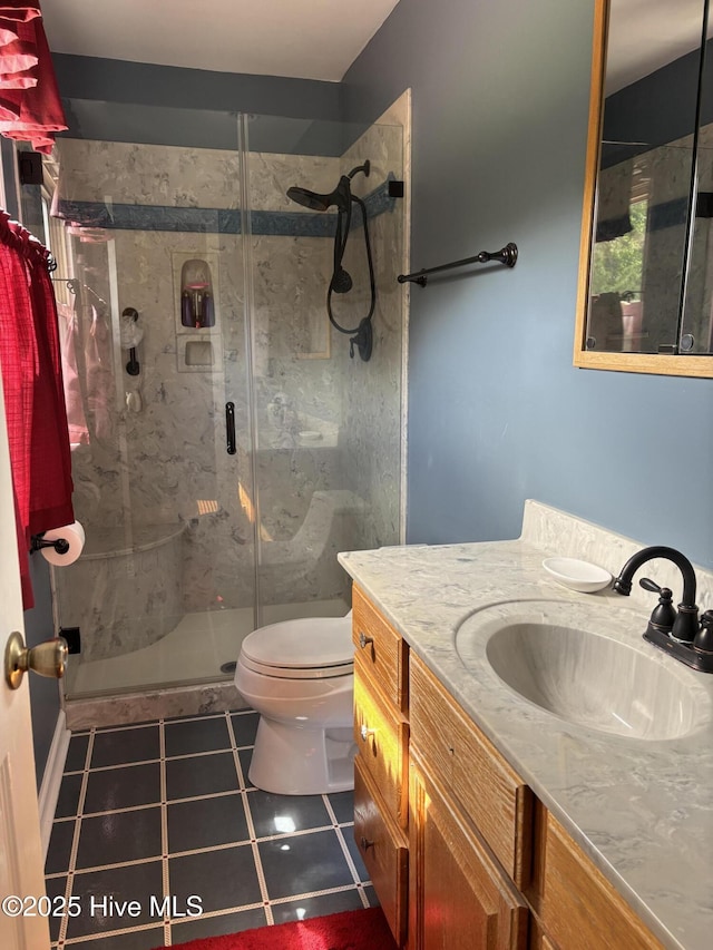full bathroom with vanity, toilet, tile patterned flooring, and a stall shower