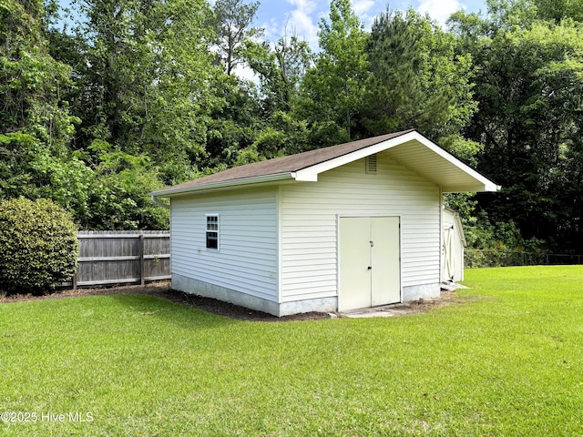 view of outbuilding featuring an outbuilding and fence