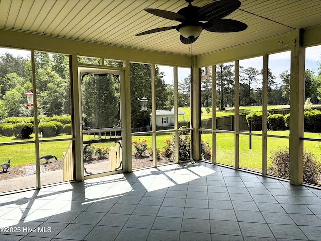 unfurnished sunroom with a ceiling fan