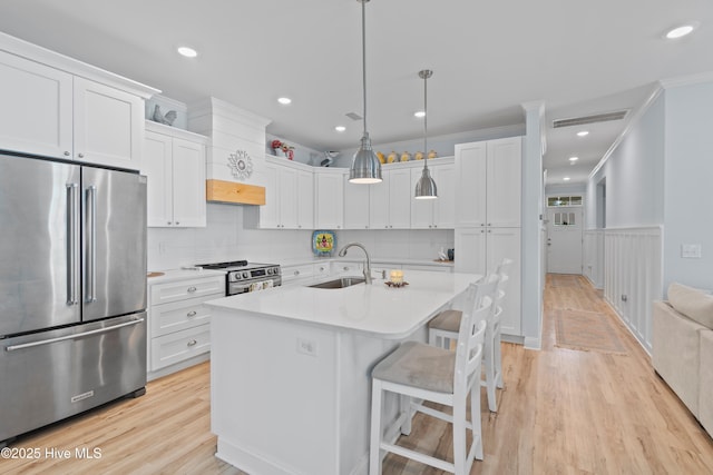 kitchen with visible vents, a sink, appliances with stainless steel finishes, and light countertops