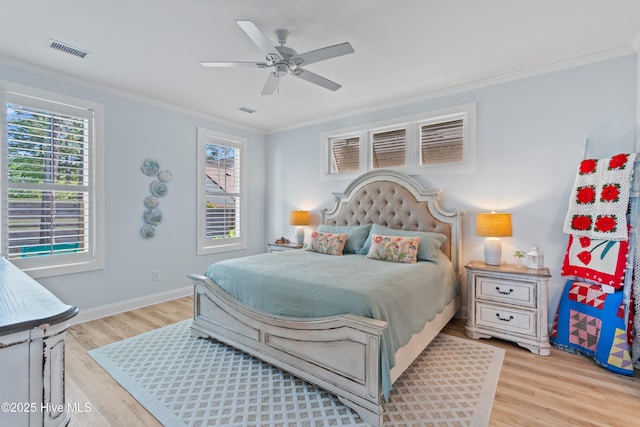 bedroom featuring crown molding, baseboards, visible vents, and light wood-type flooring