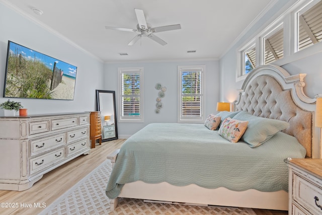 bedroom with crown molding, multiple windows, and light wood-style flooring