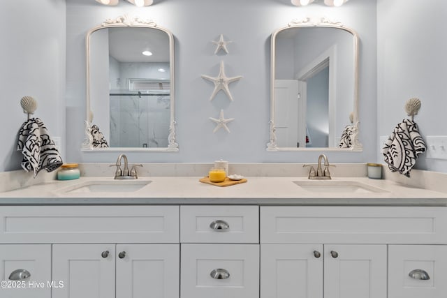 full bathroom featuring double vanity, a sink, and a marble finish shower