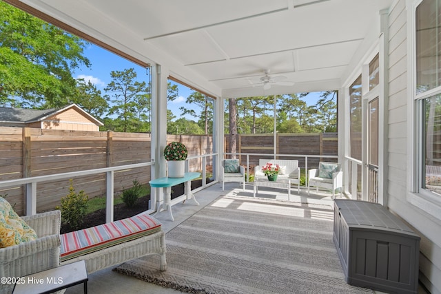 sunroom / solarium with a ceiling fan, an outdoor living space, and a wealth of natural light