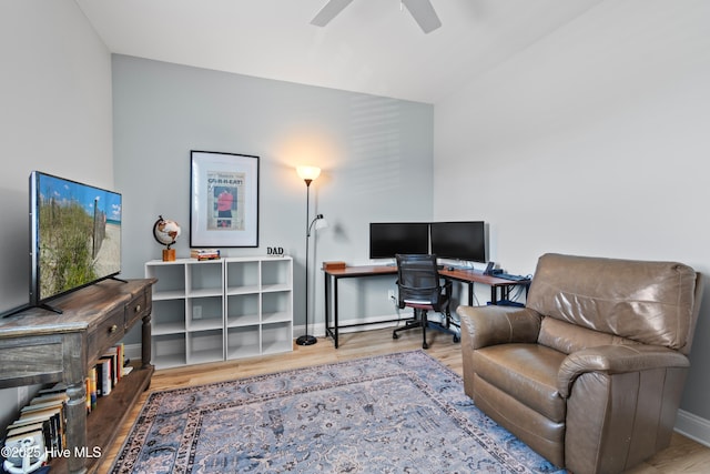 office space with baseboards, a ceiling fan, and wood finished floors