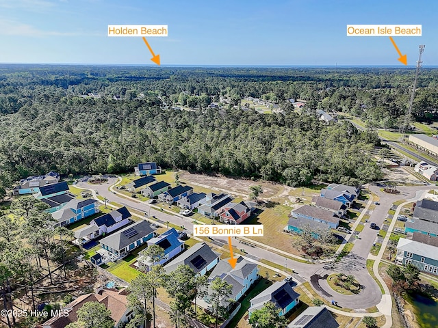 aerial view with a residential view and a view of trees