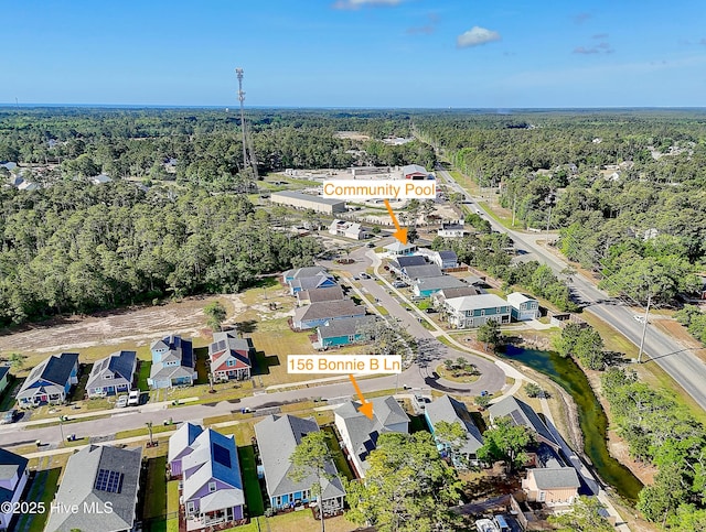 birds eye view of property with a forest view and a residential view