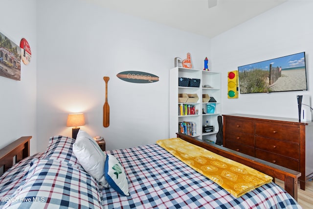 bedroom with a ceiling fan and wood finished floors