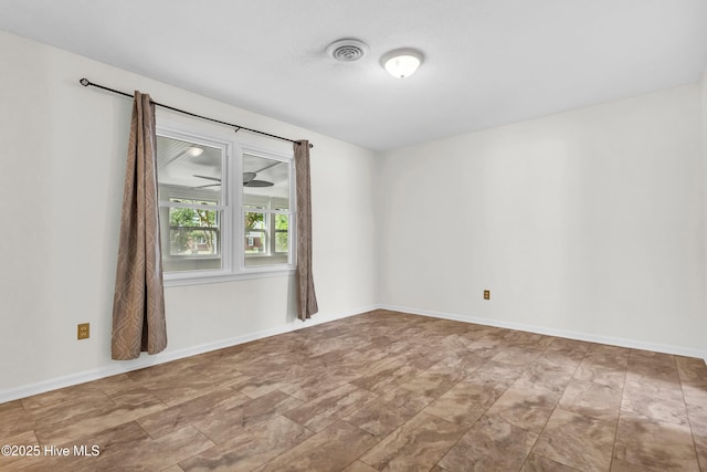 empty room featuring visible vents and baseboards