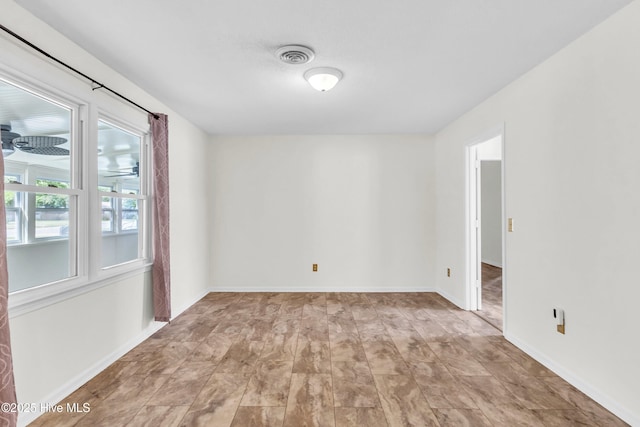 empty room with visible vents and baseboards