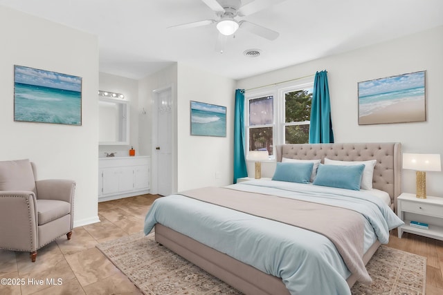 bedroom with ensuite bathroom, a ceiling fan, and visible vents