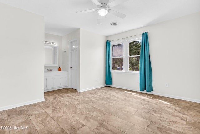 unfurnished bedroom with visible vents, baseboards, ensuite bathroom, and ceiling fan