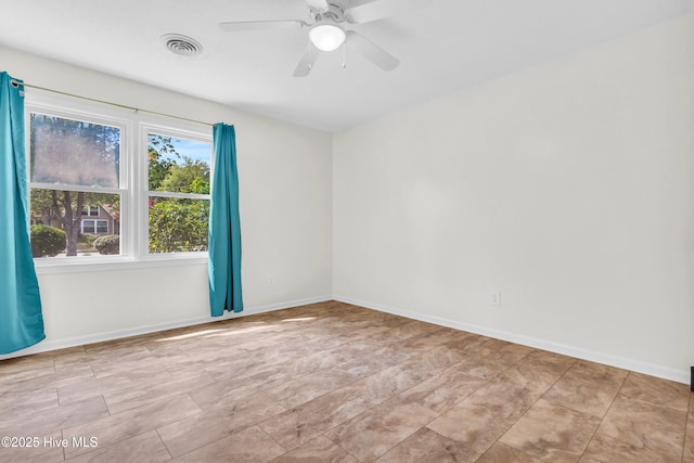 empty room featuring visible vents, baseboards, and ceiling fan