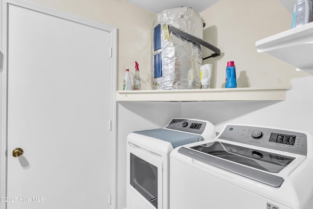 washroom with washing machine and clothes dryer and laundry area
