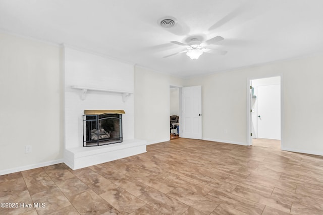unfurnished living room featuring a brick fireplace, ceiling fan, visible vents, and crown molding