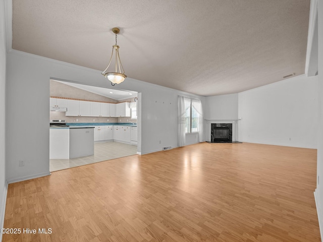 305 Cottontail Run, Newport, NC 28570 - unfurnished living room featuring light wood-type flooring, a high end fireplace, a textured ceiling, and visible vents