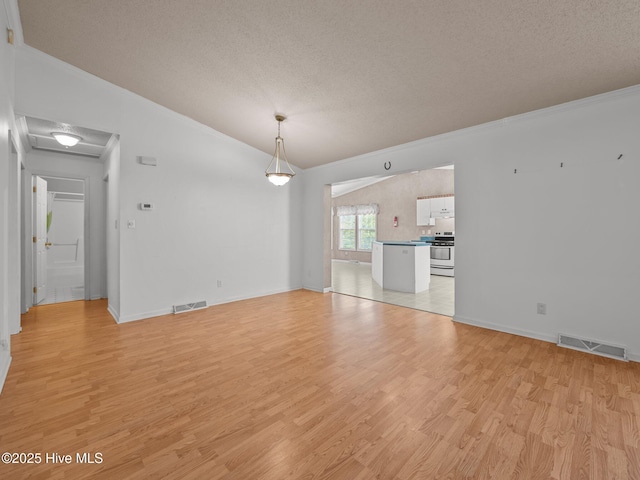 305 Cottontail Run, Newport, NC 28570 - unfurnished dining area featuring a textured ceiling, visible vents, ornamental molding, and light wood-type flooring