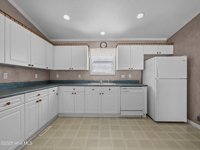 305 Cottontail Run, Newport, NC 28570 - kitchen with a sink, dark countertops, white cabinets, and white appliances
