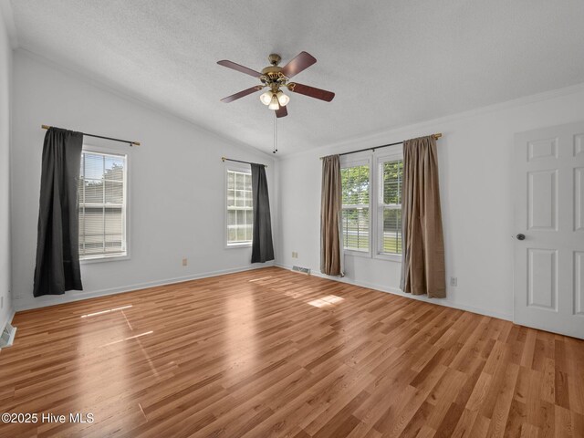 305 Cottontail Run, Newport, NC 28570 - unfurnished room with visible vents, a textured ceiling, a ceiling fan, light wood finished floors, and vaulted ceiling
