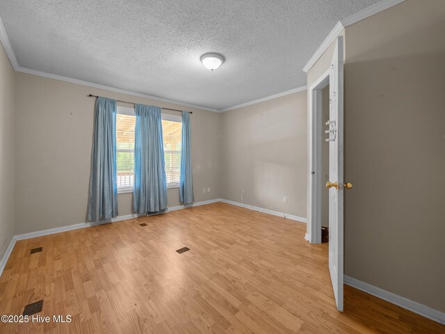 305 Cottontail Run, Newport, NC 28570 - unfurnished room with a textured ceiling, ornamental molding, and light wood-type flooring