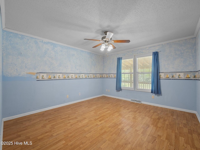 305 Cottontail Run, Newport, NC 28570 - empty room with ceiling fan, a textured ceiling, visible vents, crown molding, and wood finished floors