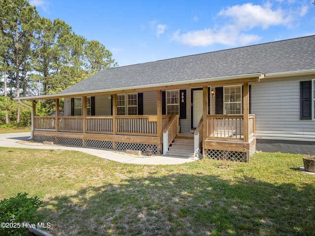 305 Cottontail Run, Newport, NC 28570 - view of front of home featuring covered porch, a front yard, and roof with shingles