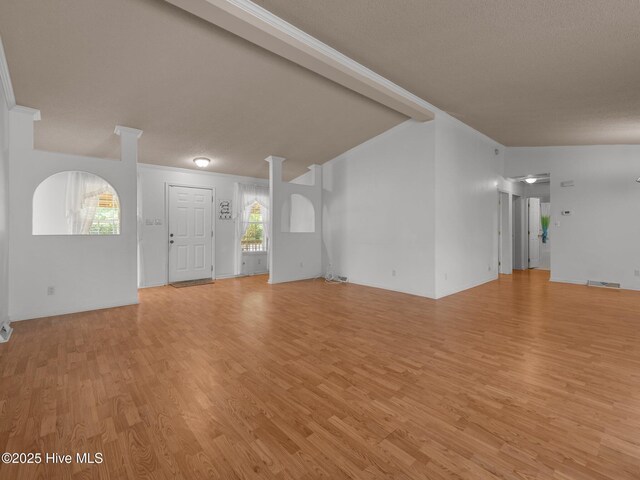 305 Cottontail Run, Newport, NC 28570 - unfurnished living room with crown molding, light wood-style flooring, and visible vents