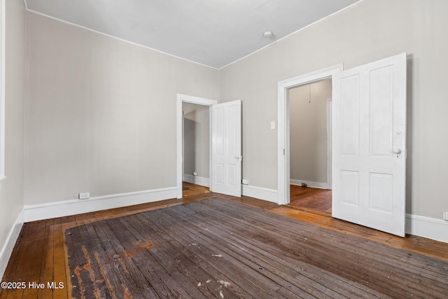 unfurnished bedroom with wood-type flooring and baseboards