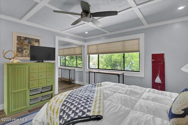109 Teakwood Dr Unit 802, Carolina Beach, NC 28428 - bedroom with coffered ceiling, multiple windows, wood finished floors, ornamental molding, and a ceiling fan