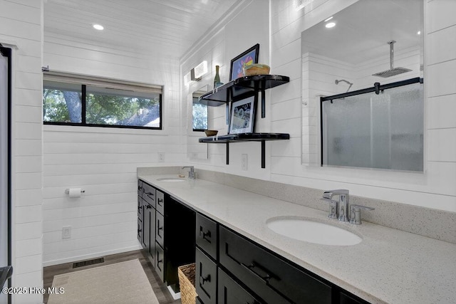 109 Teakwood Dr Unit 802, Carolina Beach, NC 28428 - full bath with double vanity, a stall shower, ornamental molding, wood finished floors, and recessed lighting