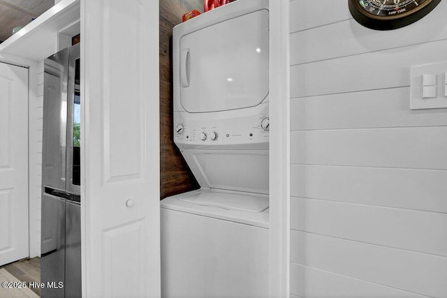 109 Teakwood Dr Unit 802, Carolina Beach, NC 28428 - laundry room with stacked washing machine and dryer and wood finished floors