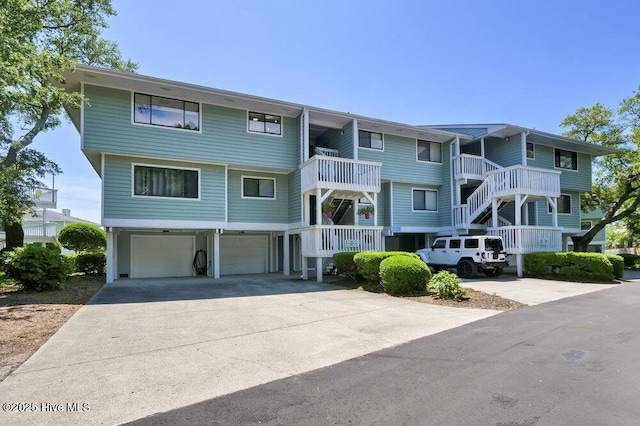 109 Teakwood Dr Unit 802, Carolina Beach, NC 28428 - view of building exterior with a garage and concrete driveway