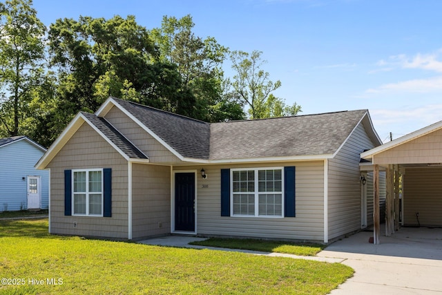 308 E Ashe St, Burgaw, NC 28425 - single story home featuring roof with shingles, a carport, a front lawn, and driveway