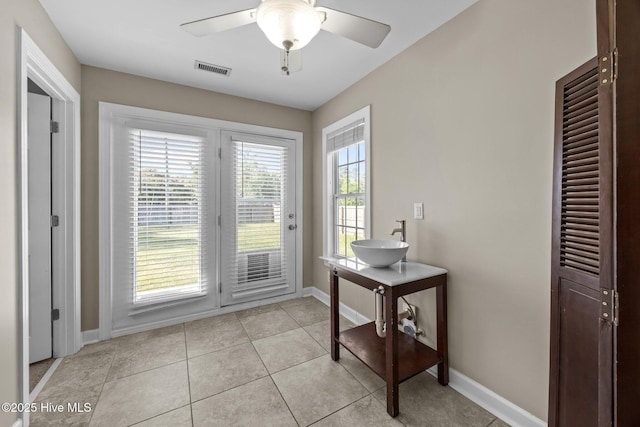 308 E Ashe St, Burgaw, NC 28425 - doorway with a ceiling fan, baseboards, light tile patterned floors, visible vents, and a sink