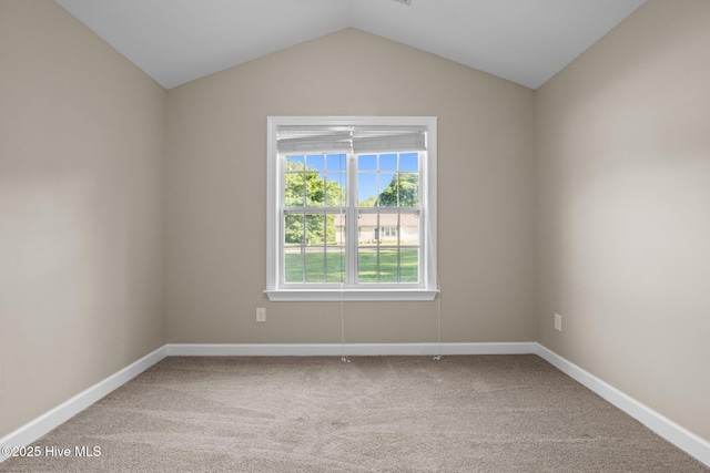 308 E Ashe St, Burgaw, NC 28425 - spare room with lofted ceiling, baseboards, and carpet