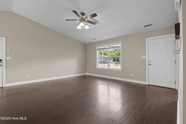 308 E Ashe St, Burgaw, NC 28425 - unfurnished living room with lofted ceiling, visible vents, dark wood-style flooring, a ceiling fan, and baseboards