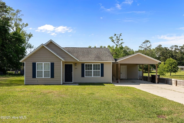 308 E Ashe St, Burgaw, NC 28425 - ranch-style home featuring concrete driveway, a front yard, roof with shingles, and a carport