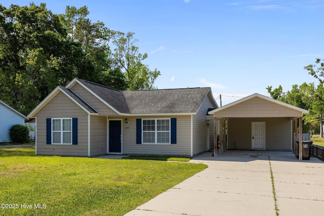 308 E Ashe St, Burgaw, NC 28425 - ranch-style house with concrete driveway, roof with shingles, a front lawn, and a carport