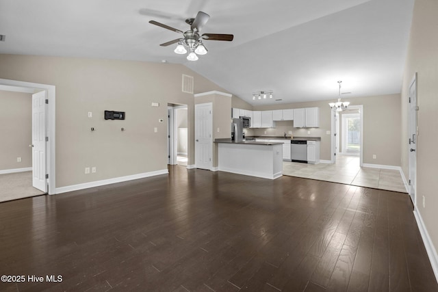 308 E Ashe St, Burgaw, NC 28425 - unfurnished living room with ceiling fan with notable chandelier, visible vents, vaulted ceiling, baseboards, and light wood-style floors