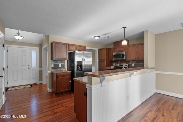 2202 Sweet Bay Dr Unit B, Greenville, NC 27834 - kitchen with appliances with stainless steel finishes, dark wood finished floors, brown cabinets, and a peninsula