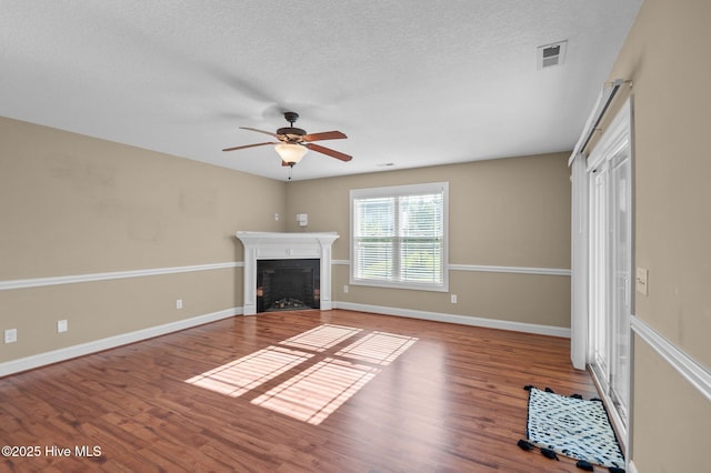 2202 Sweet Bay Dr Unit B, Greenville, NC 27834 - unfurnished living room featuring a fireplace, a ceiling fan, wood finished floors, a textured ceiling, and baseboards