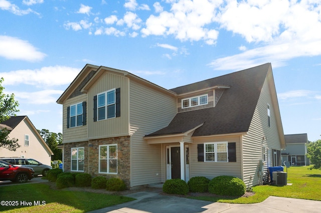 2202 Sweet Bay Dr Unit B, Greenville, NC 27834 - view of front of home featuring stone siding, a front yard, and central air condition unit