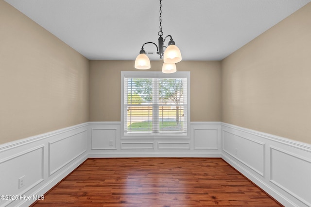 2202 Sweet Bay Dr Unit B, Greenville, NC 27834 - unfurnished room featuring a chandelier, a wainscoted wall, and wood finished floors
