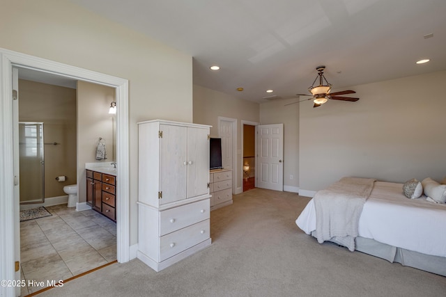 bedroom featuring recessed lighting, baseboards, light carpet, and ensuite bathroom