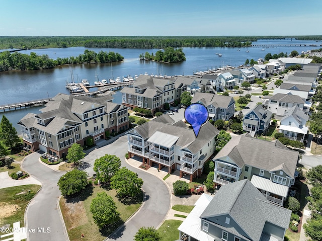 drone / aerial view featuring a water view and a residential view
