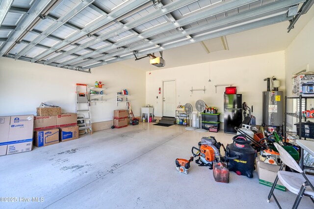garage with water heater, a garage door opener, freestanding refrigerator, and a sink