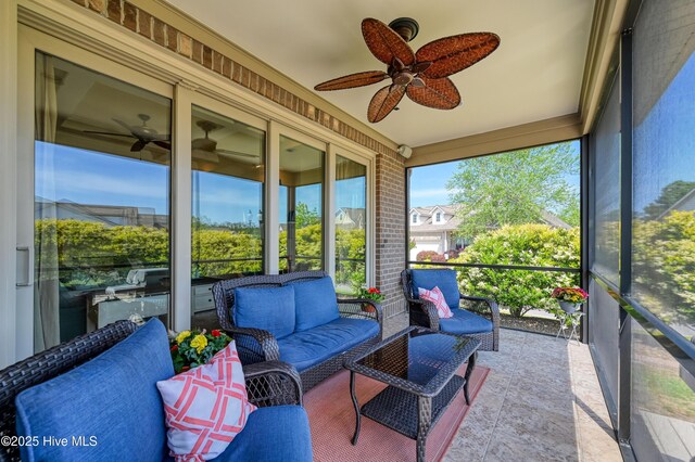 sunroom / solarium featuring ceiling fan and an outdoor hangout area