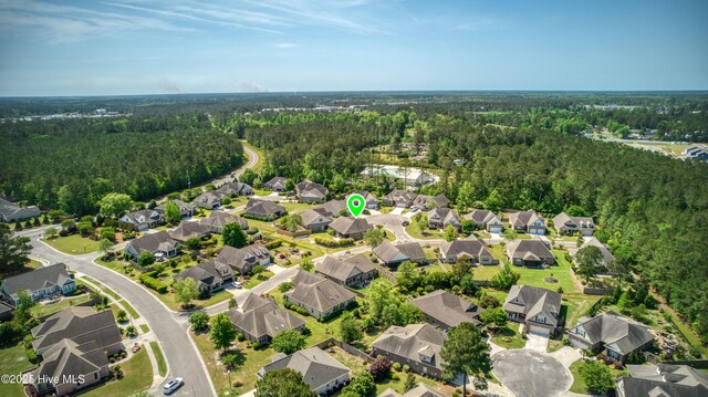 aerial view featuring a residential view and a wooded view