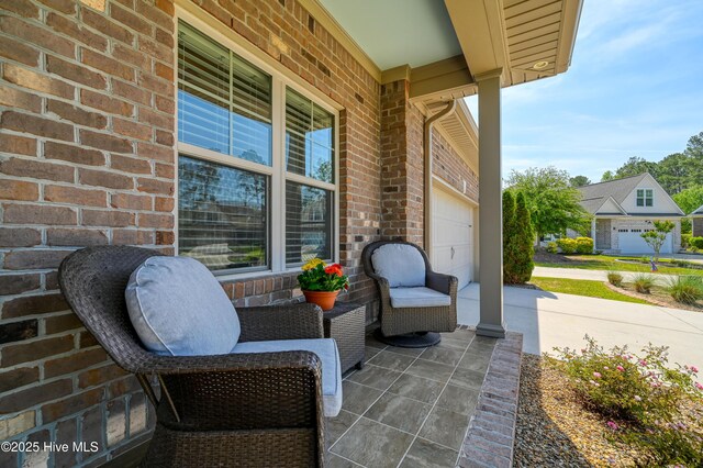 view of patio / terrace featuring a porch and driveway
